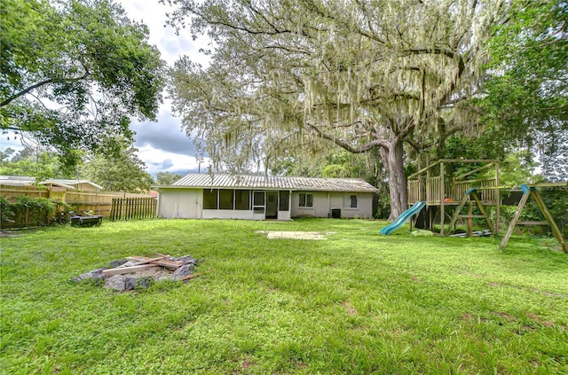 37740 Waverly Ave, Zephyrhills, FL 33542 - rear view of property with a playground and a metal roof