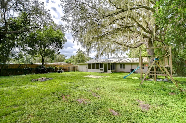 37740 Waverly Ave, Zephyrhills, FL 33542 - fenced backyard with a playground and a sunroom