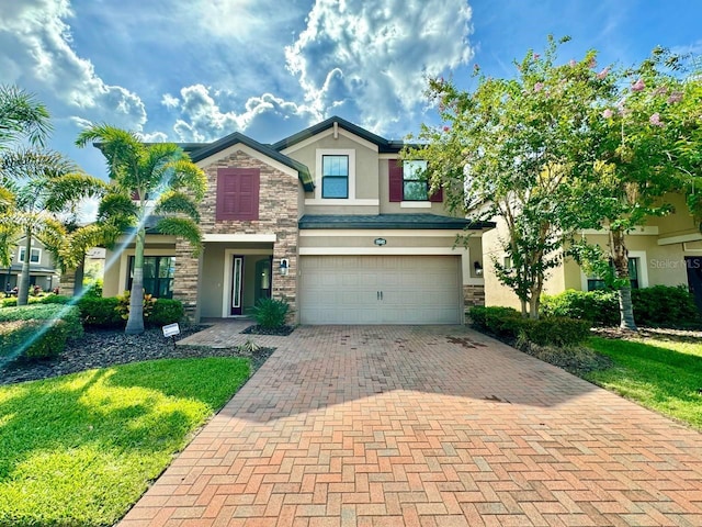 19502 Sea Myrtle Way, Tampa, FL 33647 - craftsman-style house with stone siding, stucco siding, decorative driveway, an attached garage, and a front lawn