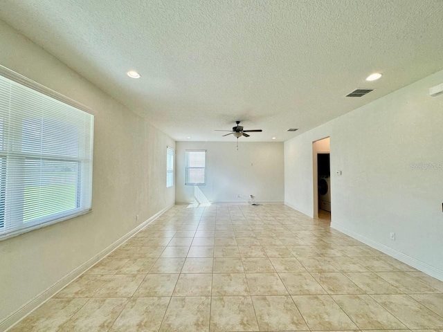 19502 Sea Myrtle Way, Tampa, FL 33647 - spare room with a ceiling fan, a textured ceiling, washer / dryer, recessed lighting, and light tile patterned flooring