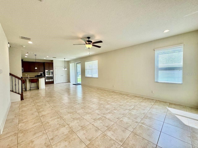 19502 Sea Myrtle Way, Tampa, FL 33647 - unfurnished living room with a ceiling fan, light tile patterned floors, recessed lighting, and a textured ceiling