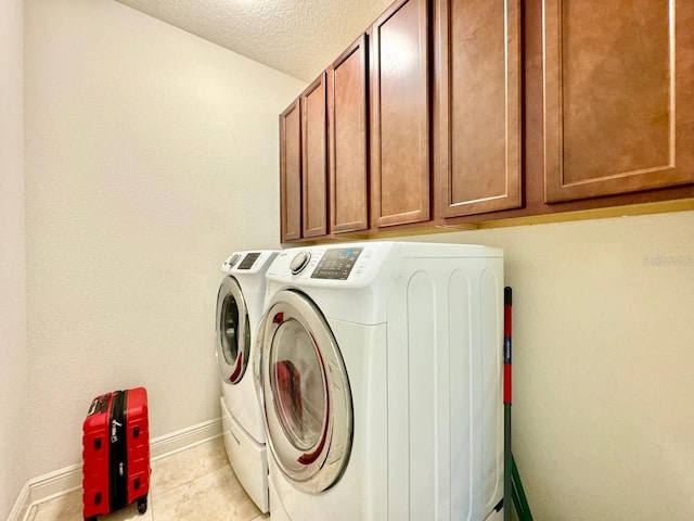 19502 Sea Myrtle Way, Tampa, FL 33647 - washroom with washing machine and clothes dryer, cabinet space, a textured ceiling, and light tile patterned flooring