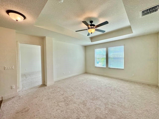 19502 Sea Myrtle Way, Tampa, FL 33647 - carpeted empty room with a textured ceiling, a tray ceiling, and a ceiling fan