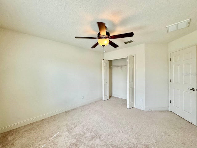19502 Sea Myrtle Way, Tampa, FL 33647 - unfurnished bedroom featuring light carpet, a closet, a textured ceiling, and ceiling fan
