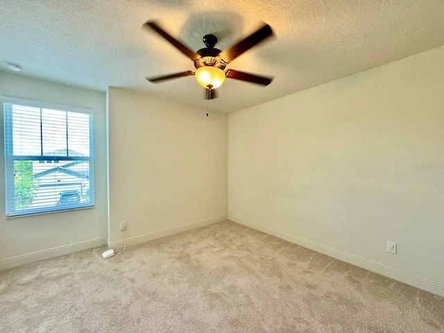 19502 Sea Myrtle Way, Tampa, FL 33647 - empty room with a textured ceiling, light colored carpet, and a ceiling fan