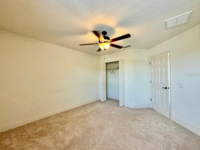 19502 Sea Myrtle Way, Tampa, FL 33647 - unfurnished bedroom with light colored carpet, a textured ceiling, a closet, and a ceiling fan