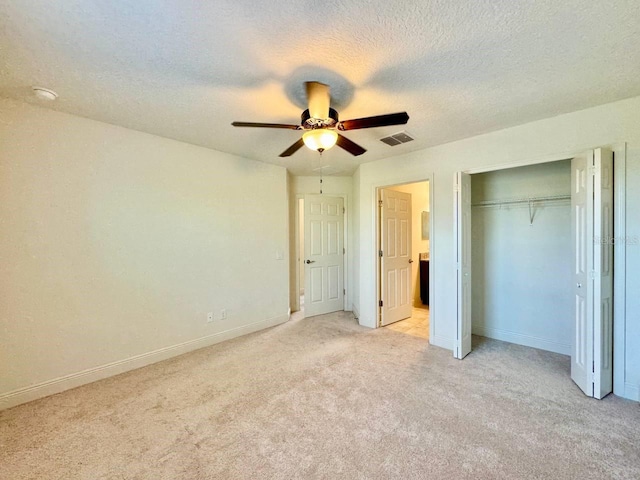 19502 Sea Myrtle Way, Tampa, FL 33647 - unfurnished bedroom featuring light colored carpet, a textured ceiling, a closet, and a ceiling fan
