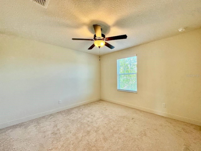 19502 Sea Myrtle Way, Tampa, FL 33647 - spare room with a smoke detector, a ceiling fan, light colored carpet, and a textured ceiling