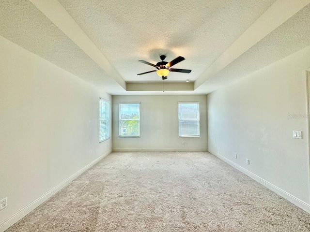 19502 Sea Myrtle Way, Tampa, FL 33647 - carpeted empty room featuring a textured ceiling, ceiling fan, and a tray ceiling