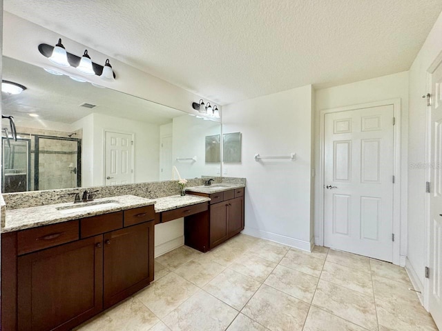 19502 Sea Myrtle Way, Tampa, FL 33647 - bathroom featuring a stall shower, two vanities, a textured ceiling, and tile patterned floors