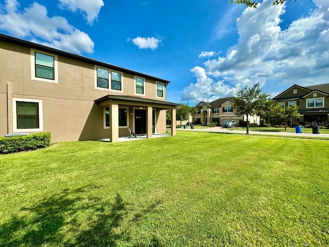 19502 Sea Myrtle Way, Tampa, FL 33647 - rear view of property with stucco siding, a lawn, and a residential view