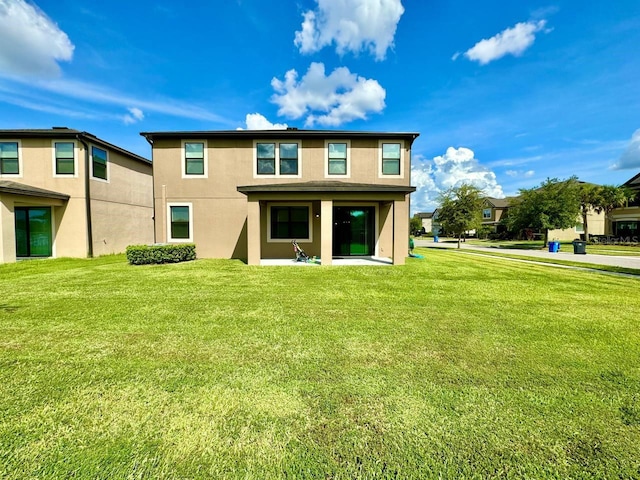 19502 Sea Myrtle Way, Tampa, FL 33647 - back of house with stucco siding, a yard, and a patio area