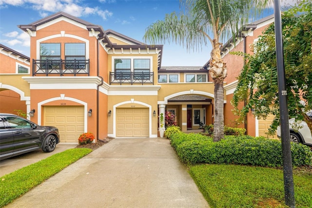 9237 Fox Sparrow Rd, Tampa, FL 33626 - townhome / multi-family property with a balcony, a garage, concrete driveway, and stucco siding