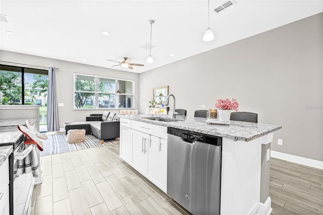 9237 Fox Sparrow Rd, Tampa, FL 33626 - kitchen featuring stainless steel dishwasher, open floor plan, wood finish floors, white cabinets, and decorative light fixtures