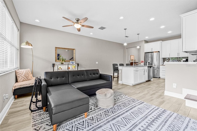 9237 Fox Sparrow Rd, Tampa, FL 33626 - living room with light wood-type flooring, a ceiling fan, and recessed lighting