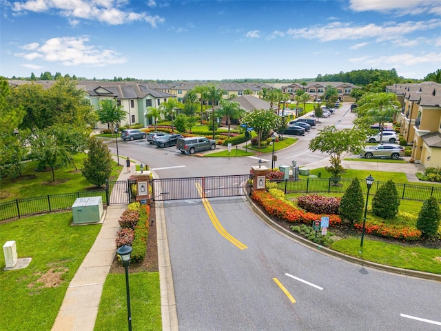9237 Fox Sparrow Rd, Tampa, FL 33626 - view of asphalt road with a gate, a residential view, curbs, and street lighting