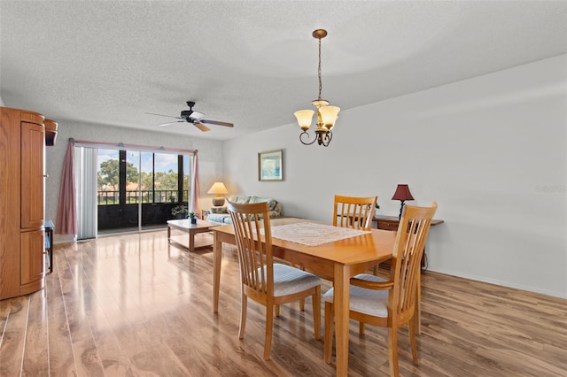 5920 80th St N Unit 308, Saint Petersburg, FL 33709 - dining area featuring light wood-type flooring, a ceiling fan, a textured ceiling, and a chandelier