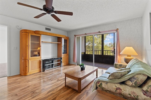 5920 80th St N Unit 308, Saint Petersburg, FL 33709 - living area with a textured ceiling, light wood-style flooring, and ceiling fan