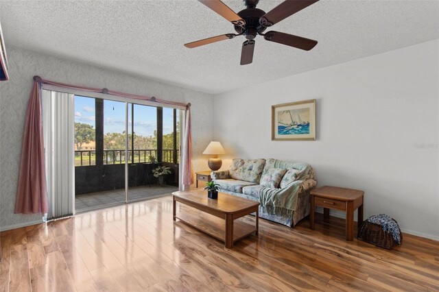 5920 80th St N Unit 308, Saint Petersburg, FL 33709 - living area featuring wood finished floors, a textured ceiling, and ceiling fan