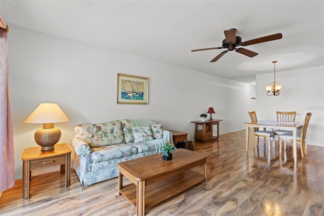 5920 80th St N Unit 308, Saint Petersburg, FL 33709 - living area with wood finished floors, a ceiling fan, and a textured ceiling