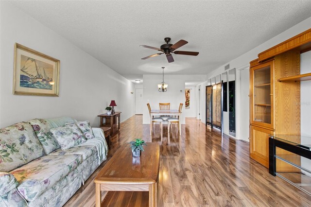 5920 80th St N Unit 308, Saint Petersburg, FL 33709 - living area with wood finished floors, ceiling fan, a textured ceiling, and a chandelier