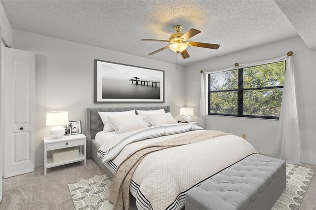 5920 80th St N Unit 308, Saint Petersburg, FL 33709 - bedroom with light colored carpet, a textured ceiling, and ceiling fan
