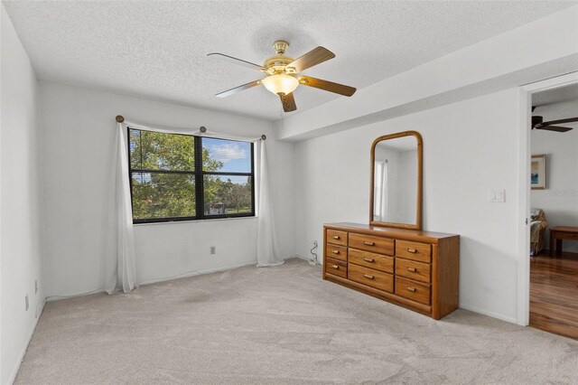 5920 80th St N Unit 308, Saint Petersburg, FL 33709 - bedroom featuring carpet floors, a textured ceiling, and ceiling fan