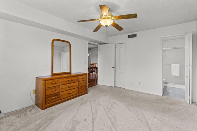 5920 80th St N Unit 308, Saint Petersburg, FL 33709 - bedroom with carpet, connected bathroom, a ceiling fan, and a textured ceiling