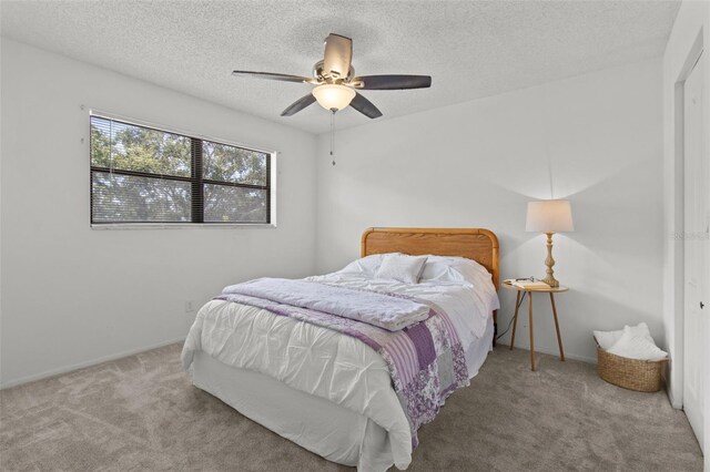 5920 80th St N Unit 308, Saint Petersburg, FL 33709 - carpeted bedroom with a textured ceiling and a ceiling fan