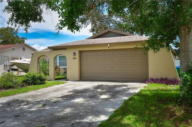 11990 104th Ave, Largo, FL 33778 - view of front of home featuring driveway, stucco siding, and a garage
