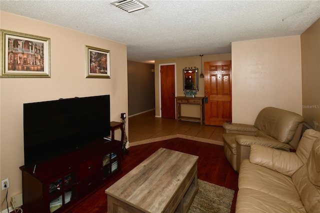 11990 104th Ave, Largo, FL 33778 - living area featuring dark wood-type flooring and a textured ceiling