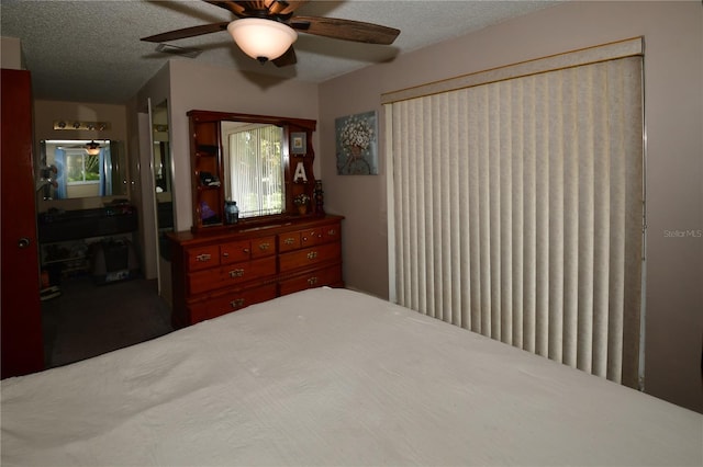 11990 104th Ave, Largo, FL 33778 - bedroom with a textured ceiling, a ceiling fan, and ensuite bathroom