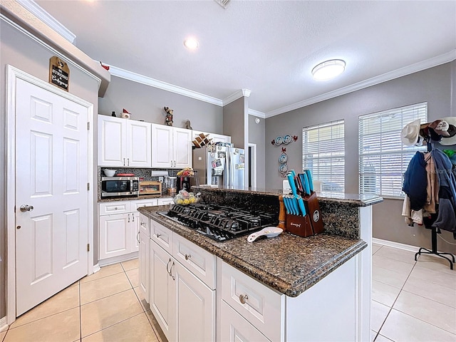 3108 Tom Matthews Rd, Lakeland, FL 33810 - kitchen with appliances with stainless steel finishes, light tile patterned floors, white cabinets, ornamental molding, and a center island