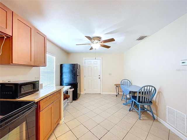 3108 Tom Matthews Rd, Lakeland, FL 33810 - kitchen with black appliances, light countertops, a ceiling fan, and light tile patterned flooring
