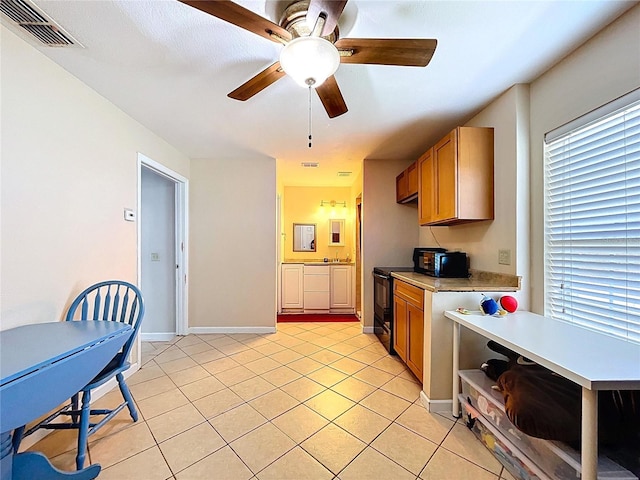 3108 Tom Matthews Rd, Lakeland, FL 33810 - kitchen with light countertops, light tile patterned floors, a ceiling fan, open shelves, and brown cabinetry