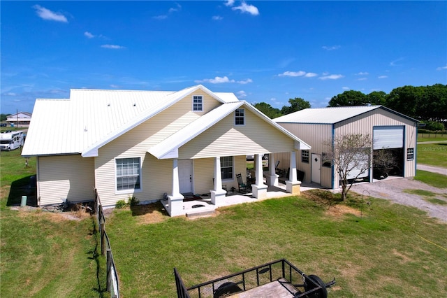 3108 Tom Matthews Rd, Lakeland, FL 33810 - back of property with a metal roof, a patio area, a garage, and driveway