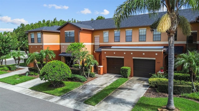 30151 Goodwick Way, Wesley Chapel, FL 33543 - multi unit property with stucco siding, a garage, and driveway