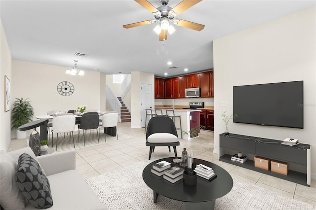 30151 Goodwick Way, Wesley Chapel, FL 33543 - living room featuring stairway, light tile patterned floors, a chandelier, ceiling fan, and recessed lighting