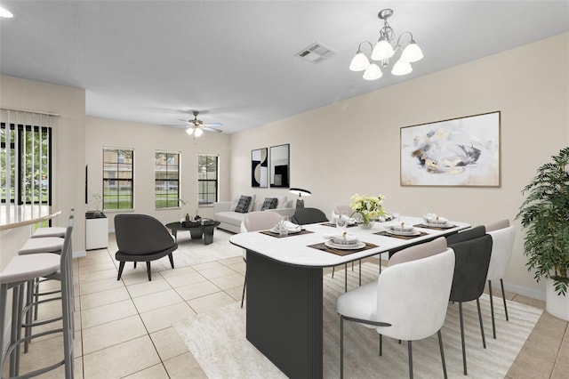 30151 Goodwick Way, Wesley Chapel, FL 33543 - dining space with light tile patterned flooring, a chandelier, and a ceiling fan