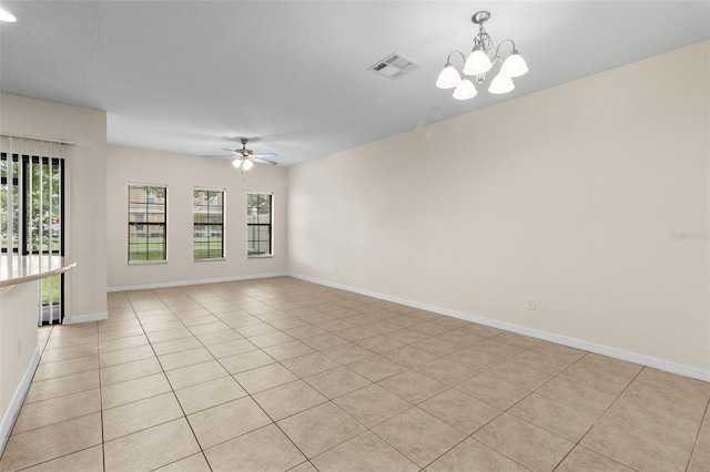30151 Goodwick Way, Wesley Chapel, FL 33543 - unfurnished room featuring ceiling fan, a chandelier, and light tile patterned flooring