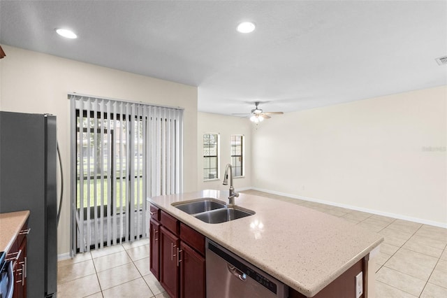 30151 Goodwick Way, Wesley Chapel, FL 33543 - kitchen with stainless steel appliances, light tile patterned floors, a ceiling fan, dark brown cabinets, and recessed lighting