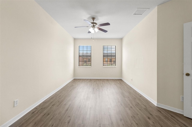 30151 Goodwick Way, Wesley Chapel, FL 33543 - unfurnished room with wood finished floors and ceiling fan