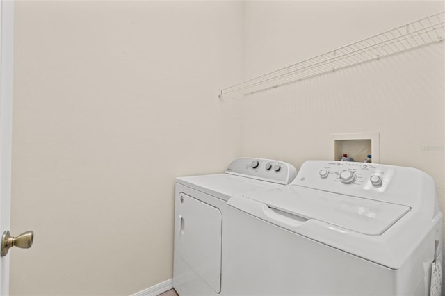 30151 Goodwick Way, Wesley Chapel, FL 33543 - laundry room with washing machine and clothes dryer and baseboards