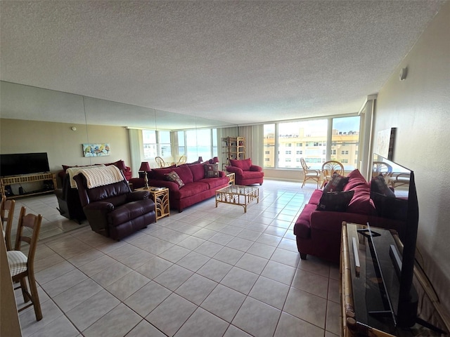 632 Edgewater Dr Unit 633, Dunedin, FL 34698 - living area featuring healthy amount of natural light, light tile patterned floors, and a textured ceiling