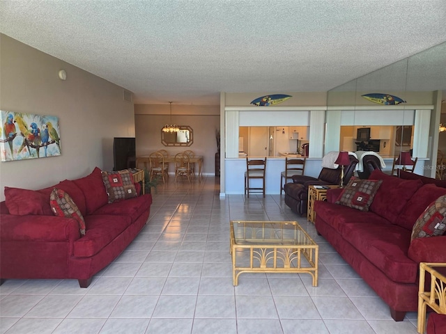 632 Edgewater Dr Unit 633, Dunedin, FL 34698 - living area with tile patterned floors, a textured ceiling, and a chandelier