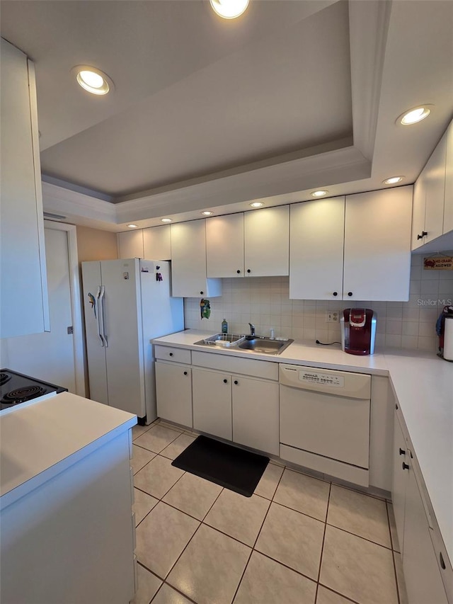 632 Edgewater Dr Unit 633, Dunedin, FL 34698 - kitchen with white appliances, white cabinets, light countertops, tasteful backsplash, and recessed lighting
