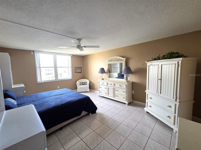632 Edgewater Dr Unit 633, Dunedin, FL 34698 - bedroom with light tile patterned flooring, a ceiling fan, and a textured ceiling
