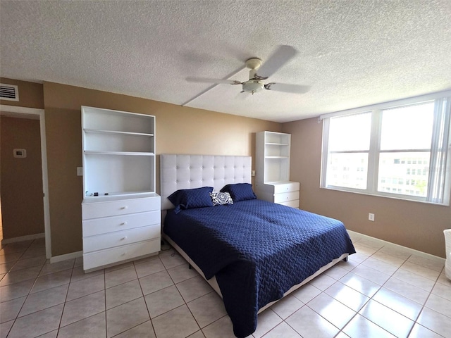 632 Edgewater Dr Unit 633, Dunedin, FL 34698 - bedroom featuring light tile patterned floors, a textured ceiling, and ceiling fan