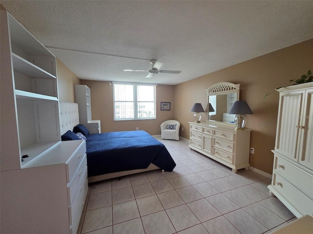632 Edgewater Dr Unit 633, Dunedin, FL 34698 - bedroom with light tile patterned floors, ceiling fan, and a textured ceiling