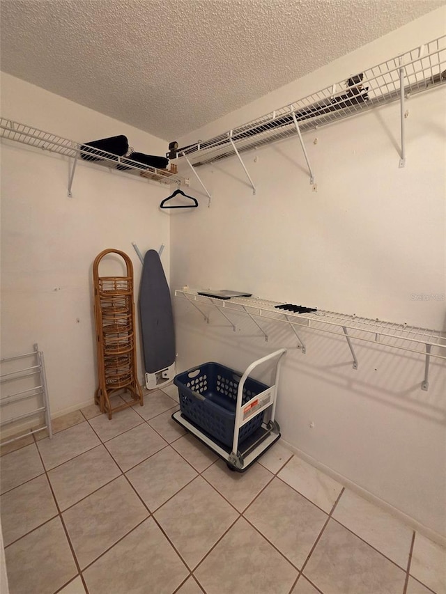 632 Edgewater Dr Unit 633, Dunedin, FL 34698 - walk in closet featuring light tile patterned floors